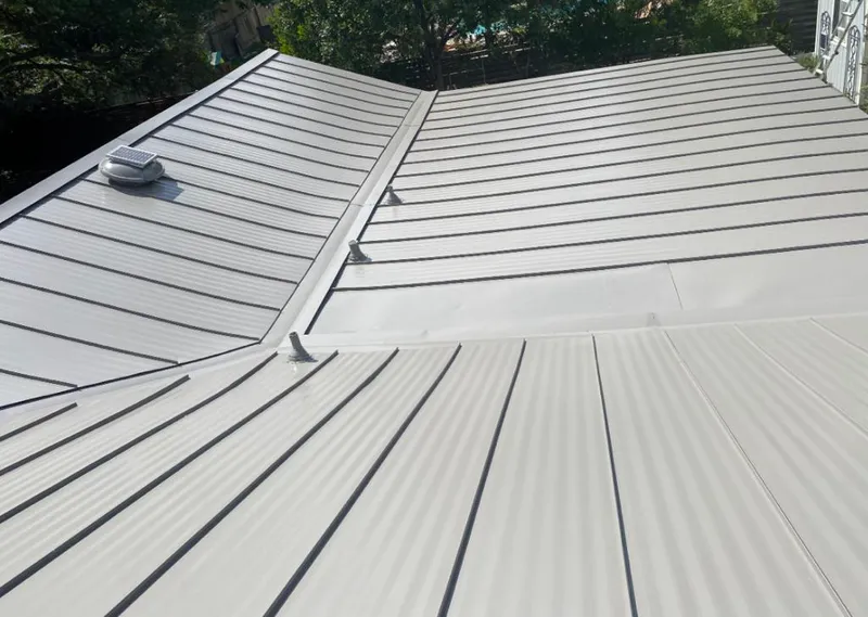 Solar attic fan installed on a metal roof for Roof Ventilation in Chesapeake Ranch Estates
